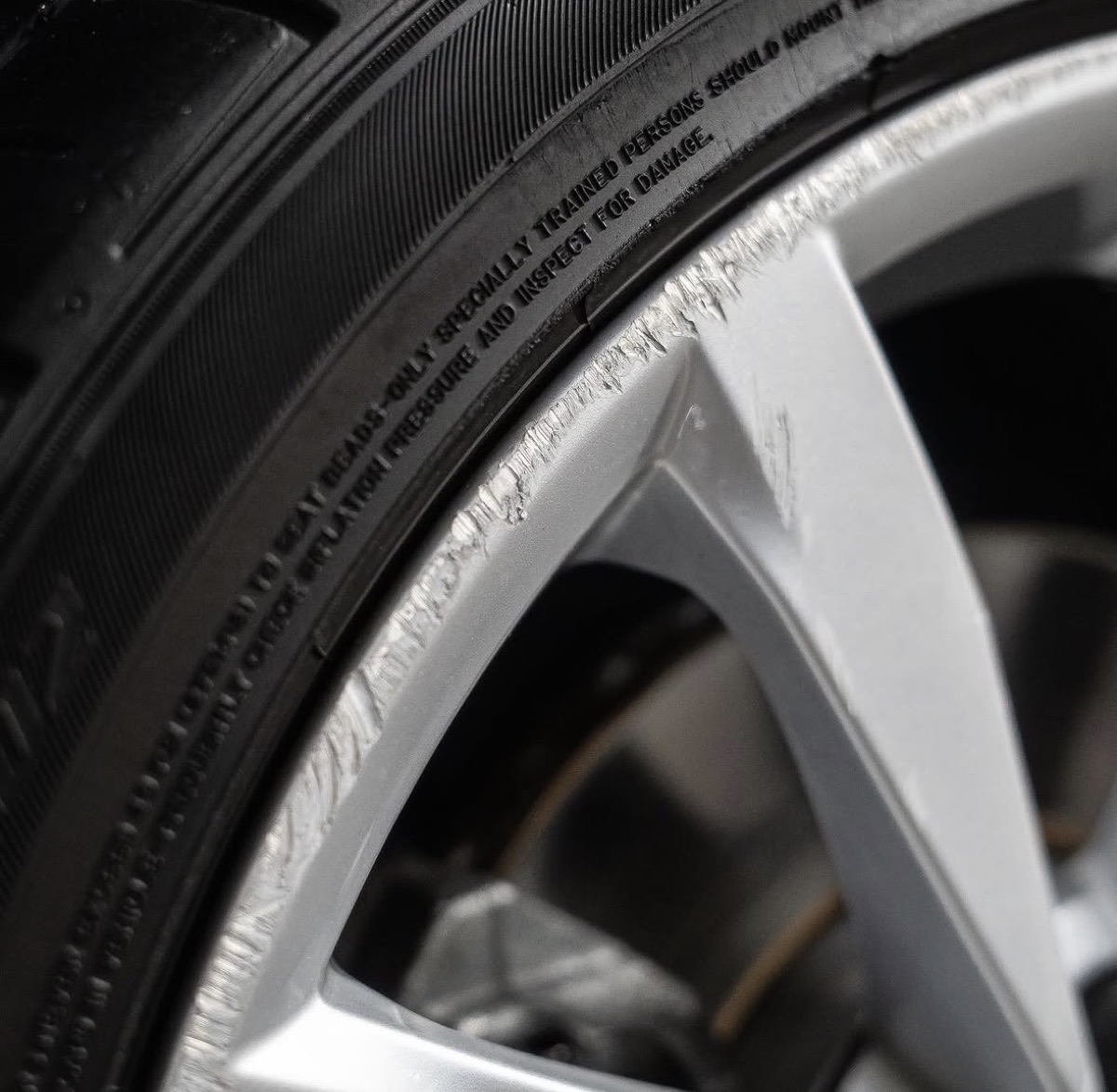 Volkswagen wheel, before repair, close-up of curb damage